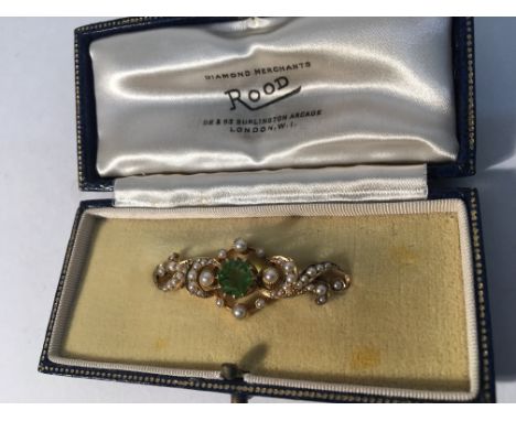 A peridot and seed pearl brooch.