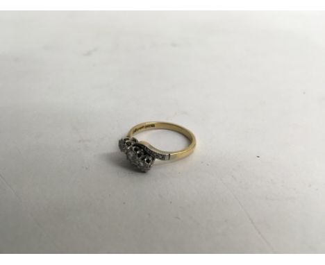 A three stone 18ct gold and platinum mounted ring. Weight approx 4gSize approx N