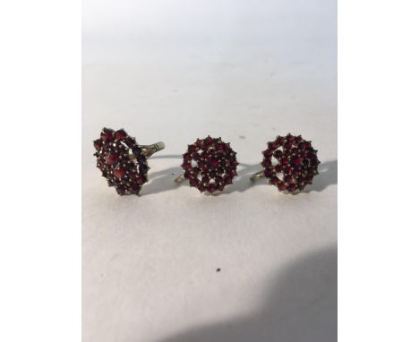 A garnet and gold jewellery set with a ring and a pair of earrings. Weight approx 9.8g Ring size approx L