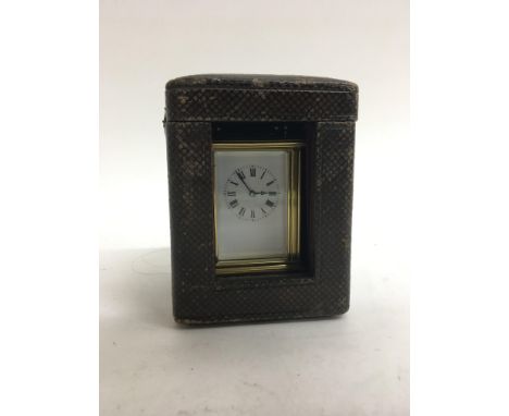 A miniature brass carriage clock.