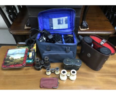 An Olympus cased camera and four pairs of vintage binoculars