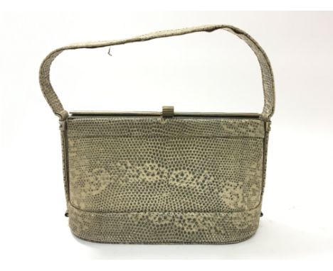 A small vintage snakeskin handbag with brass clip and fitted interior.