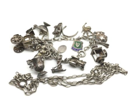 A silver charm bracelet with charms including a tractor, bagpipes and an Irish emblem weighing approximately 43 grams and a w