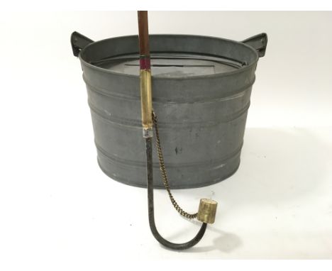 A vintage fishing gaff and a live fish bait container, 'Albatross' by Mitchell.