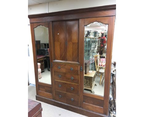 A large three part comactum comprising of two mirrored single wardrobes with a shelf and hooks and a central two door shelved