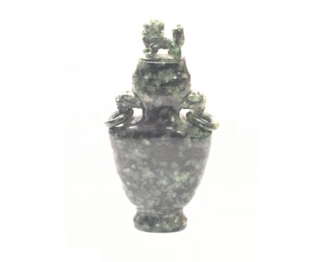 A Chinease Spinch Jade vase and cover the lid carved with a lion the sides with open rings, possibly late19th Century, height