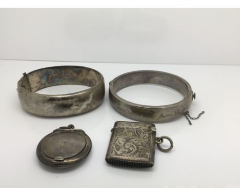 Two silver bangles, a small vesta and miniature powder compact