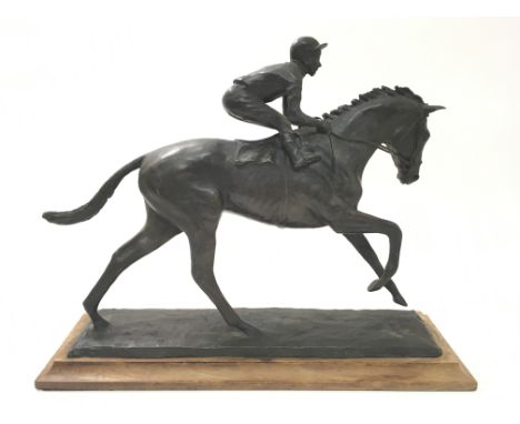 A bronze of a horse ridden by a jockey 'El Gran Senor', signed Michael Lloyd 86, 8/9 on a wooden base.