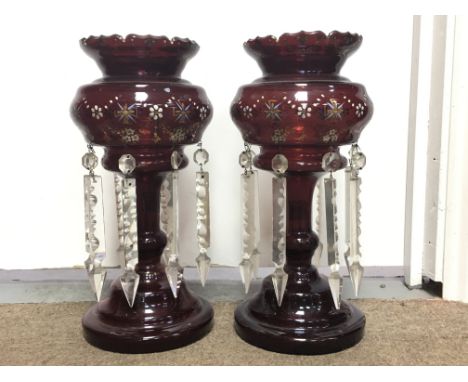 A pair of ruby red lustres with glass drops.