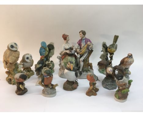 A collection of modern bird ornaments and a ceramic figural group.
