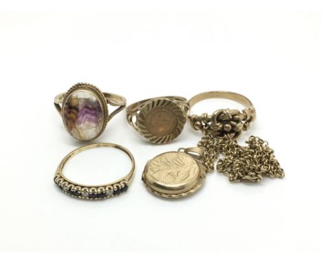 Four gold rings comprising one set with a Blue John stone, an unmarked knot ring, an eternity ring and coin set example plus 