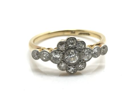 A ladies yellow gold cluster ring inset with 13 diamonds, ring size approximately M/N, total weight approximately 3 grams.