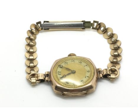 A ladies vintage 9ct gold wristwatch with Arabic numerals, total weight approximately 17 grams.