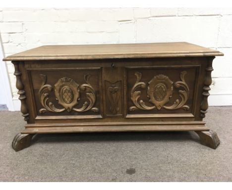 A continental Spanish trunk with applied moldings and carved panels, approximately 106cm x 52cm x 54cm tall.