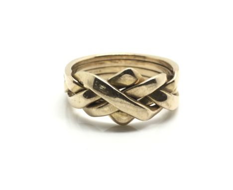 A 9ct yellow gold puzzle ring comprising of four interlocking bands, approximately 5 grams, ring size N.