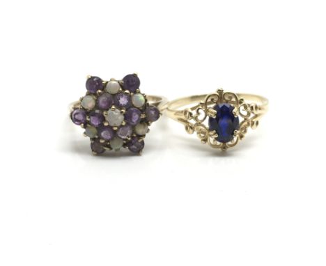 Two yellow 9ct gold decorative ladies rings, one of floral influence inset with opals and amethysts, the other having one cen