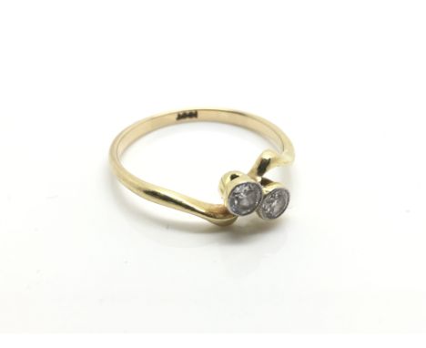 A ladies 18ct yellow gold ring inset with two diamonds, ring size approximately P, weight approximately 2 grams.