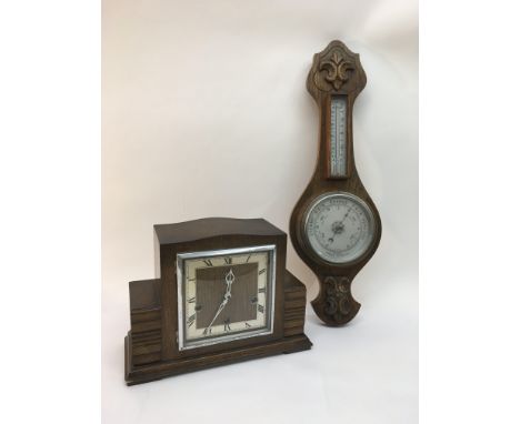 An oak barometer, walnut framed mirror and an oak mantle clock (3).