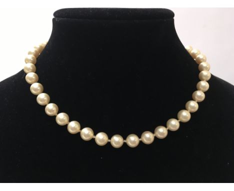 A pearl bracelet with gold tone clasp and a pearl choker necklace with silver clasp.