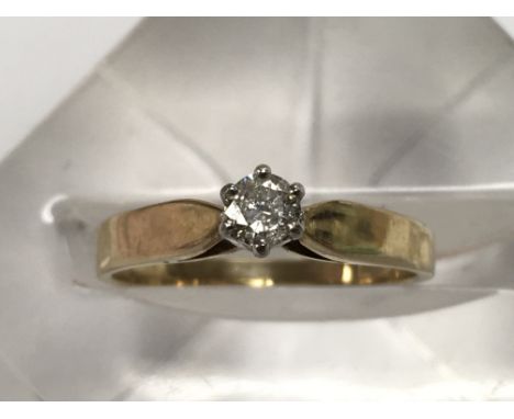 A gold diamond solitaire ring, approx .25ct