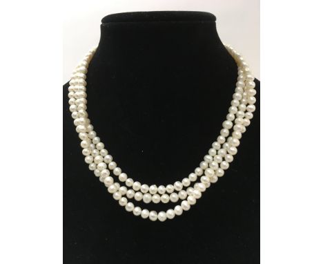 A three stranded fresh water pearl necklace with a white metal clasp stamped 925.