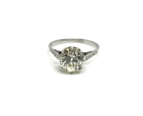 A platinum, 3.2ct diamond old cut solitaire ring flanked with diamond encrusted shanks, ring size approximately Q/R total wei