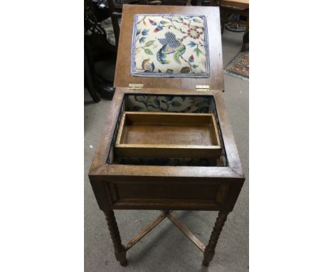 A vintage floorstanding lift top workbox on barley twist legs