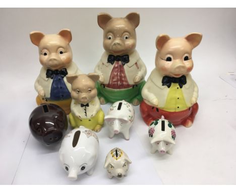 A collection of 9 ceramic piggy banks.