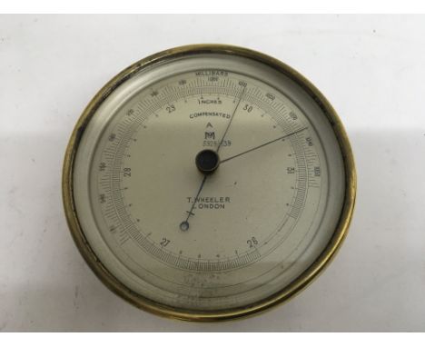 A brass cased anroid barometer by T. Wheeler of London.