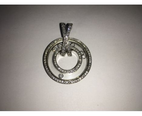 A fine quality, modern design 18ct white gold circular pendant, encrusted with fine quality diamonds, the cavity ring encapsu