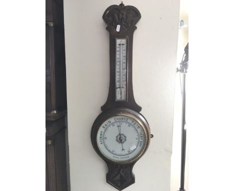 A mahogany cased aneroid wall barometer.