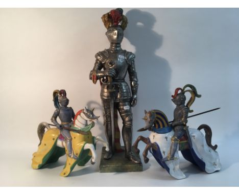 Three ceramic knights; two jousting on horseback and one stood holding a sword. As found.