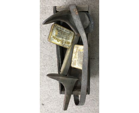 A wooden box of old cobbler's tools and lasts
