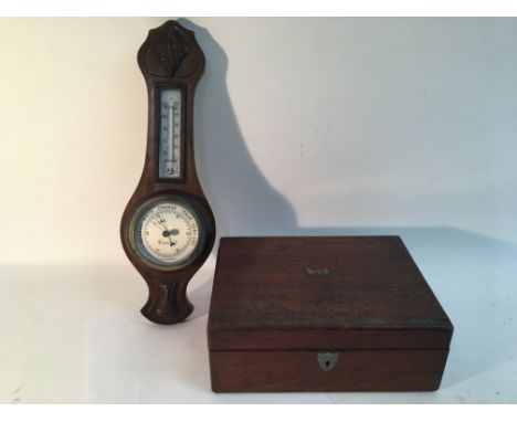 A mahogany writing slope and a barometer.