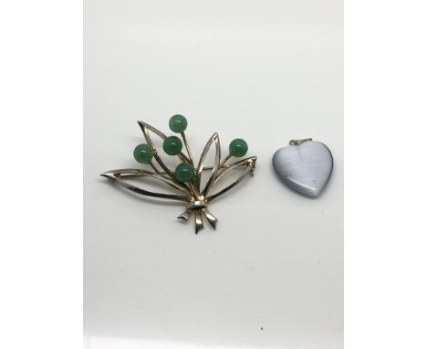 A sterling silver brooch set with jade balls and a heart shaped moonstone pendant