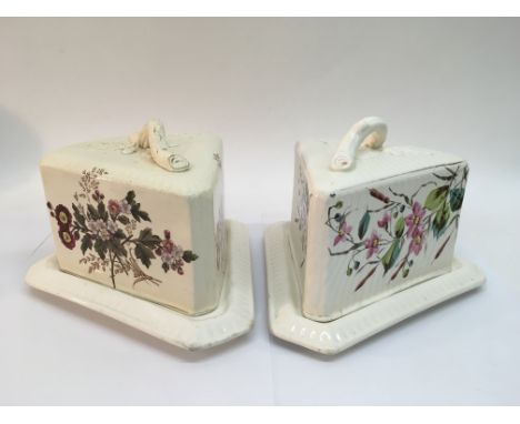Two ceramic cheese dishes and covers with floral decoration.