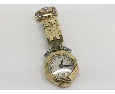 A vintage gold and diamond ladies fob watch.