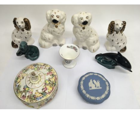 A collection of 20th Century Staffordshire dogs together with other decorative ceramics by Poole, Wedgwood and Capodimonte.