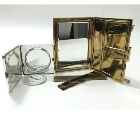 A compactum with mirror and tortoise shell comb and engine turned boxed compact.