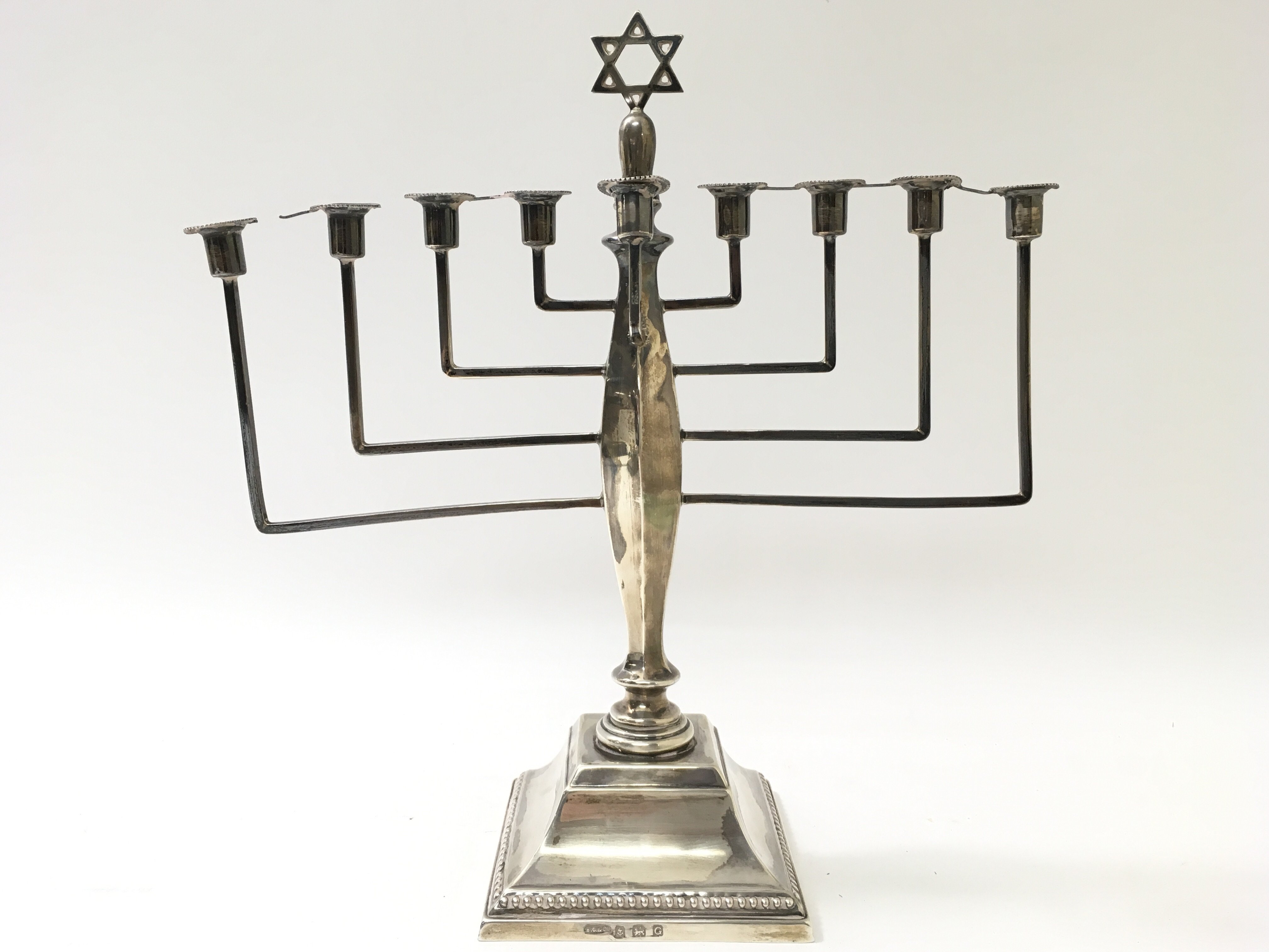 A silver candelabra of Jewish design with a central Star of David and