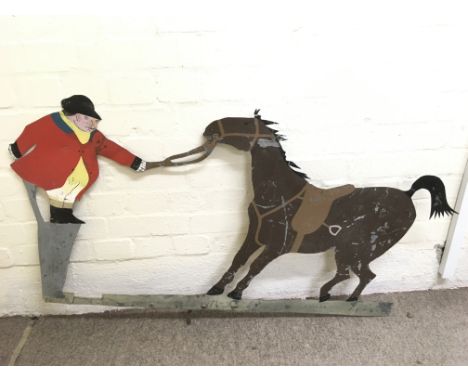 A large vintage metal cut weather vane in the form of a horse and dismounted rider in red hunting jacket, painted both sides.