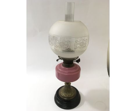 A large Victorian pink glass oil lamp and shade