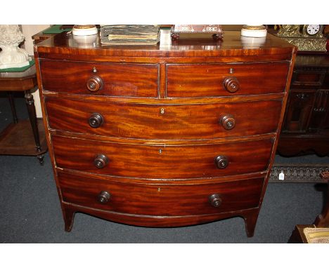 An early 19th century mahogany bow front chest of two short over three long drawers with knob handles, on bracket feet, 104cm