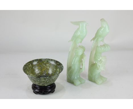 A pair of carved jadeite hoho birds (a/f) 21.5cm high together with an imitation jade bowl on hardwood stand 12.5cm diameter