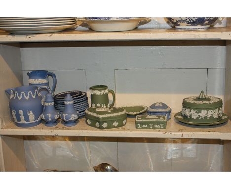 A large collection of Wedgwood and Jasperware, in light, mid and dark blue, and green, including three jugs and four jars and