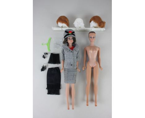 A 1959 Barbie Midge doll, wearing black underwear, tweed hat, coat and skirt, and a red body suit, together with three variou