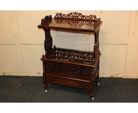 A Victorian walnut Canterbury whatnot with pierced fretwork and rectangular shelf above a three division Canterbury with sing