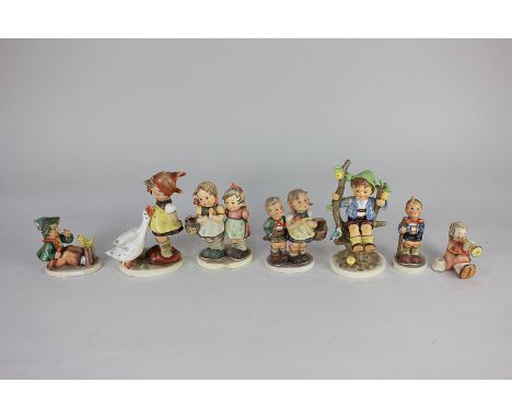 A collection of six Goebel Hummel figures including Girl with Geese, Daddy's Girls, and Little Hiker, together with another s