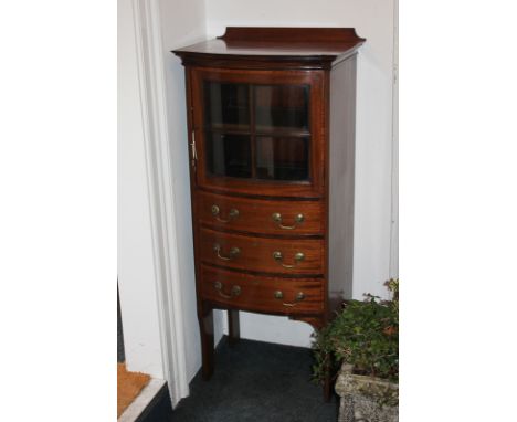 An Edwardian mahogany bow front cabinet, with glazed panel door enclosing shelf, above three drawers, on curved feet, 52.5cm