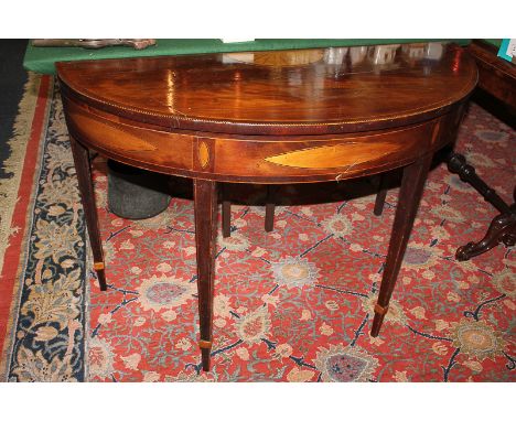 A Sheraton style inlaid mahogany semi-lune card table with cross banded top, on square tapered legs, 107cm, (a/f)